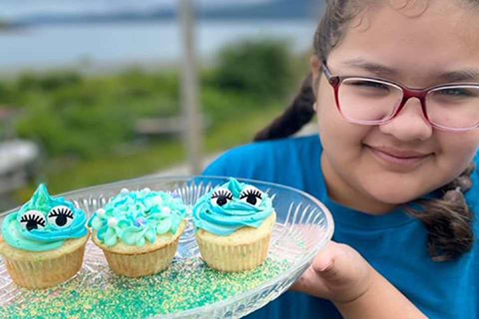 Aria Pryce holds up the creative blue cupcakes she baked for the first-ever Hiit’aG̲an.iina K̲uuyas Naay Skidegate Youth Centre COVID-19 cupcake contest, which delivered baking kits to families on Wednesday, June 10, 2020. (Hiit’aG̲an.iina K̲uuyas Naay/Skidegate Youth Centre photo)