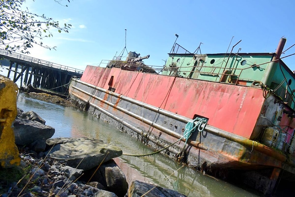 The derelict barge, the Scotch Cap, has been moored for more than 14 years at Porpoise Harbour in Port Edward when it and another vessel became unmoored, when the dock broke away, Sept. 8. (Photo: K-J Millar/the Northern View)