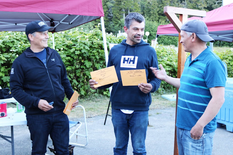 Billy Yovanovich and Trent Moraes presented Chris Edinger Jr. with his prizes during the annual COVID Catch in Skidegate on June 25. (Photo: Kaitlyn Bailey/Haida Gwaii Observer)