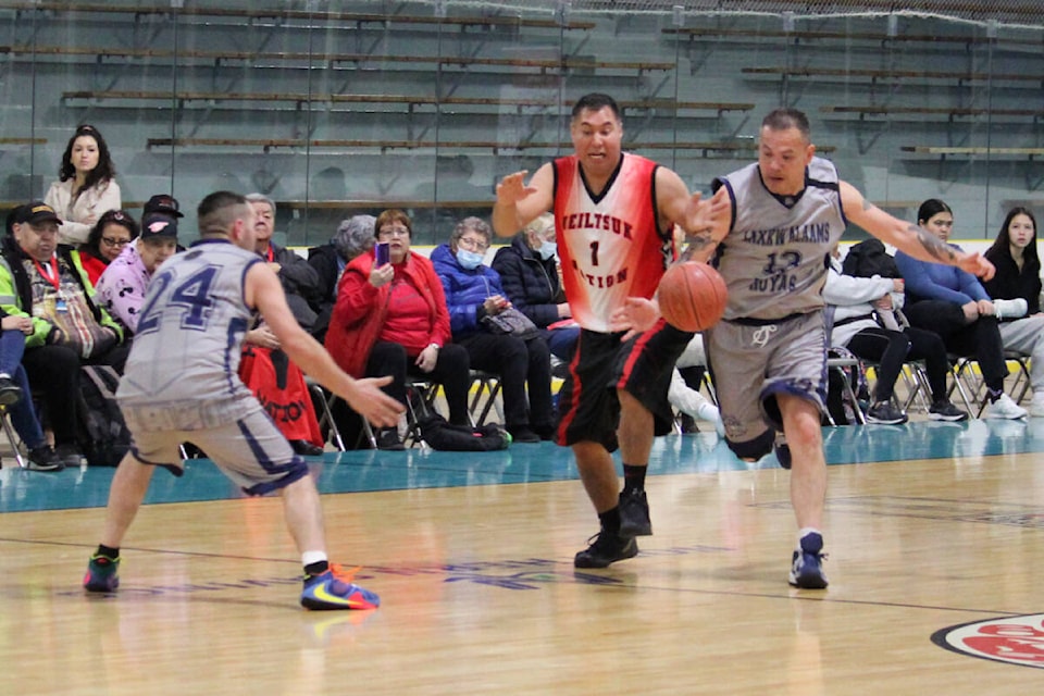 Lax Kw’alaams’ Peter Wesley, right, races Heiltsuk’s David Green to a loose ball at centre court during Masters Division play at the All Native Basketball Tournament in Prince Rupert Feb. 14. (Thom Barker photo)
