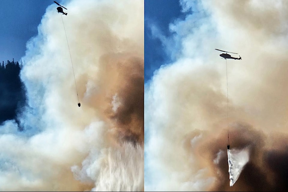 A helicopter drops water on the Sailor Bar wildfire near Yale on the afternoon of Sunday, Aug. 24.
