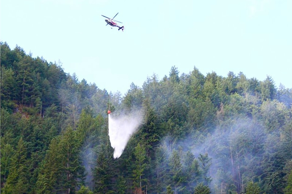 Valley Helicopters Ltd. were part of the water bucketing operations for the Serpent's Back Trail wildfire discovered on July 2. The helicopter is being piloted by Brad Fandrich. 