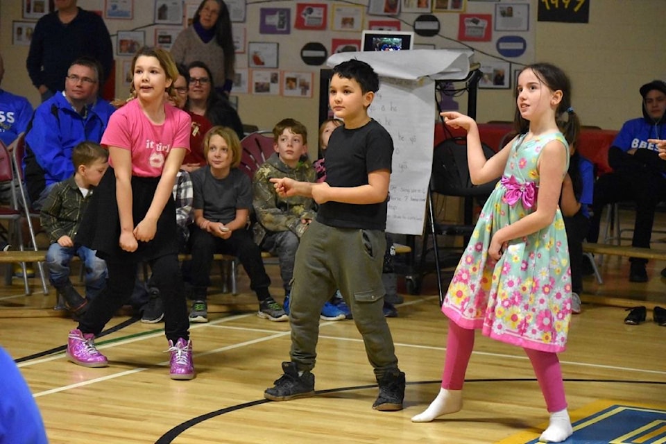 Abigail Bellerose, left, Aaden Bellerose and Jorja Fountain strike a pose during their rendition of music through the ages, from swing dance to the Village People to Bruno Mars. The Evolution of Dance performance was part of a centennial celebration for the Boston Bar school. Emelie Peacock photo