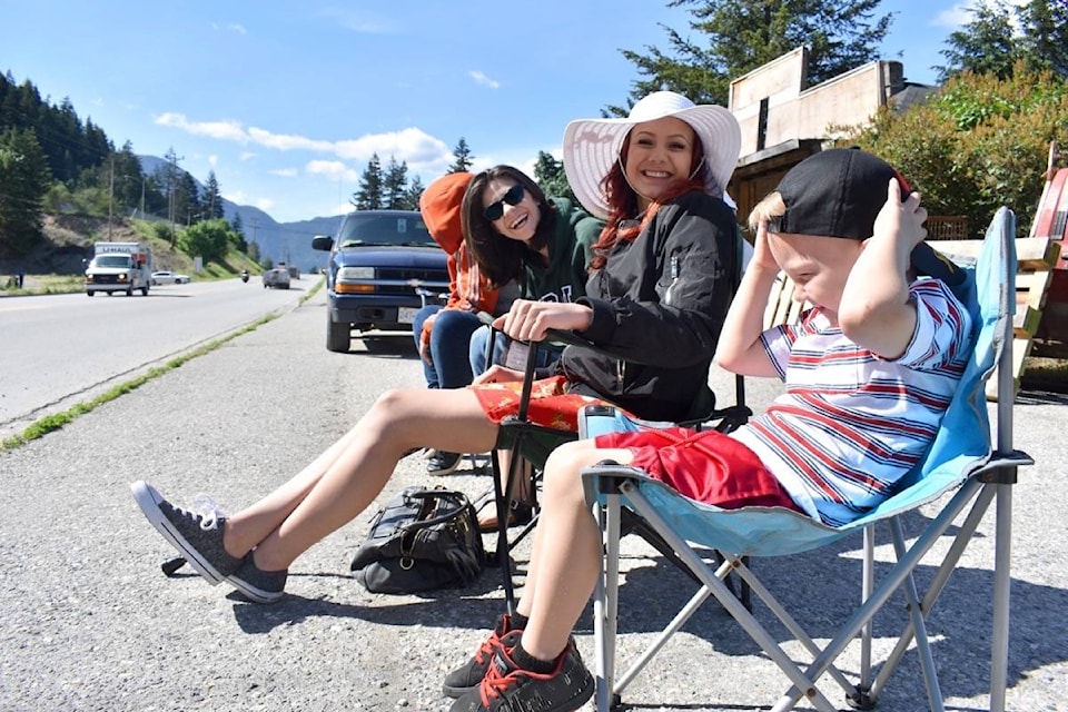 Jaycee Hope, left, Cheyenne Campbell, Leslie Campbell and Kay Dale shared some laughs as they got good roadside seats in preparation for the 91st annual May Days parade through Boston Bar.