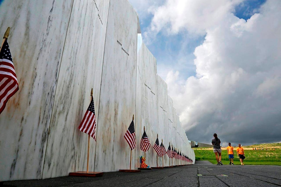 FILE – In this May 31, 2018, file photo, visitors to the Flight 93 National Memorial pause at the Wall of Names honoring 40 passengers and crew members of United Flight 93 killed when the hijacked jet crashed at the site during the 9/11 terrorist attacks, near Shanksville, Pa. Families impacted by the terrorist attacks say it’s important for the nation to pause and remember the hijacked-plane attacks that killed nearly 3,000 people at the World Trade Center, at the Pentagon and near Shanksville on Sept. 11, 2001, shaping American policy, perceptions of safety and daily life in places from airports to office buildings. (AP Photo/Gene J. Puskar, File)