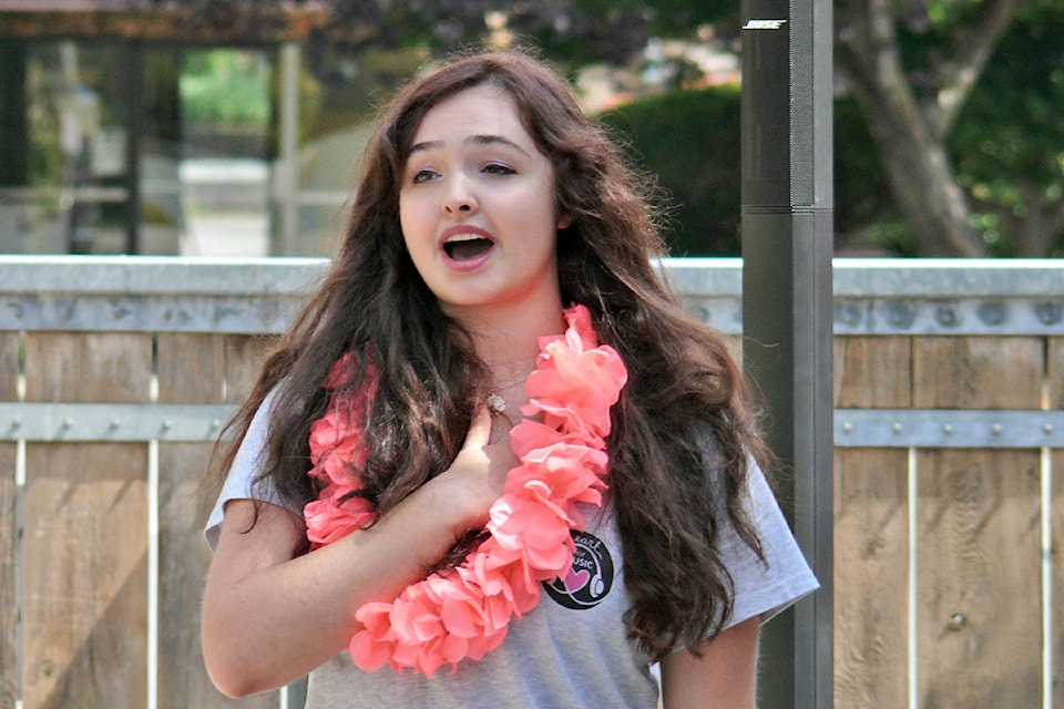 Natasha Mihell of Heart for Music B.C. sang “O Canada” before Mad Jazz performed for residents of the Langley Lodge on Monday, Aug. 8. It was part of a campaign to bring free live music to seniors during the pandemic. (Dan Ferguson/Langley Advance Times)