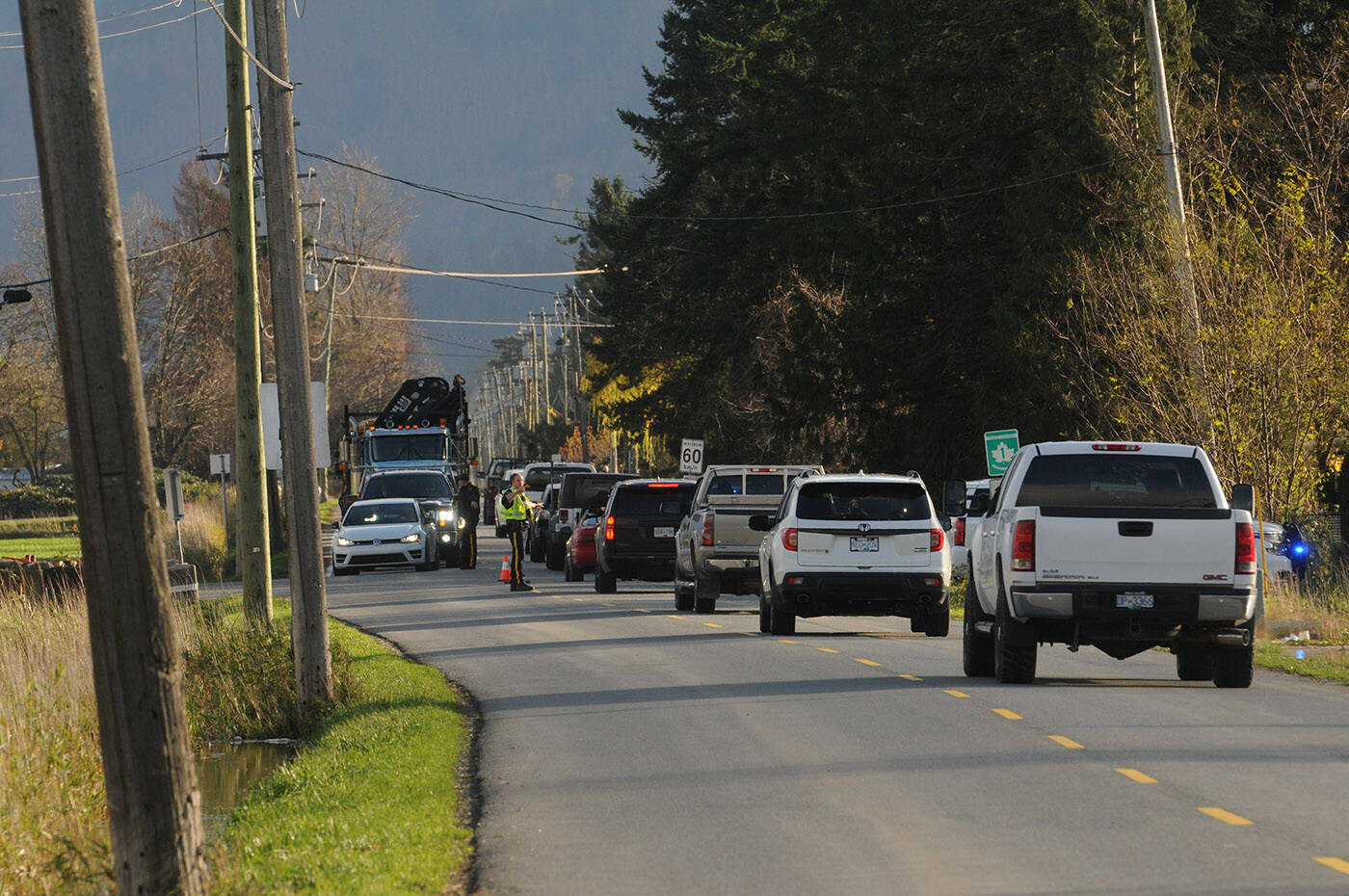RCMP officers control traffic on the east side of the Keith Wilson Bridge at Chadsey Road as folks from Sumas Prairie and Yarrow leave the area following an evacuation order on the morning of Tuesday, Nov. 16, 2021. (Jenna Hauck/ Chilliwack Progress)