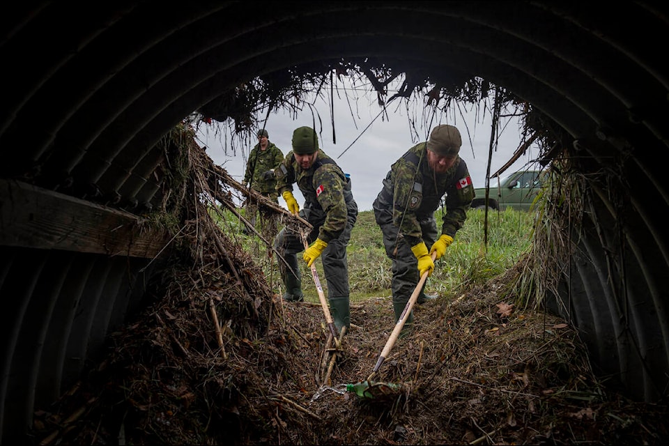 Members work on clearing culverts. (CAF photo)