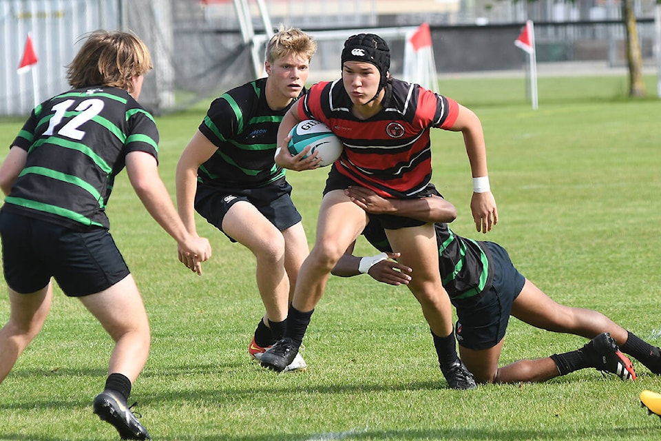 Abby Senior (in red) played against Oak Bay on Wednesday morning during the first game of the provincials at Exhibition Park in Abbotsford. The games continue through Saturday. (John Morrow/Abbotsford News)