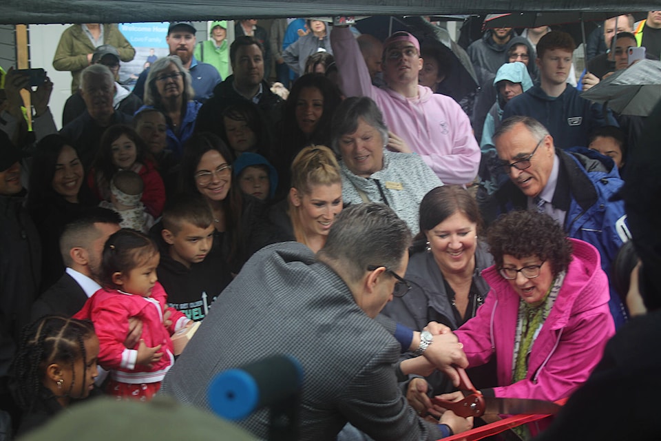 Mayor Paul Horn, Mission MLA Pam Alexis, Mission councillors, Habitat for Humanity’s VP of construction Stephani Baker, and all families cut the ribbon at the key dedication ceremony on June 9. Patrick Penner / Mission Record