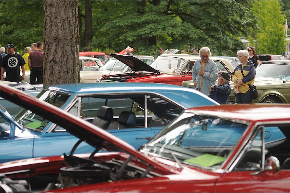 People check out vehicles during the Fraser Valley Classic Car Show at the Chilliwack UFV campus on Saturday, June 11, 2022. (Jenna Hauck/ Chilliwack Progress)
