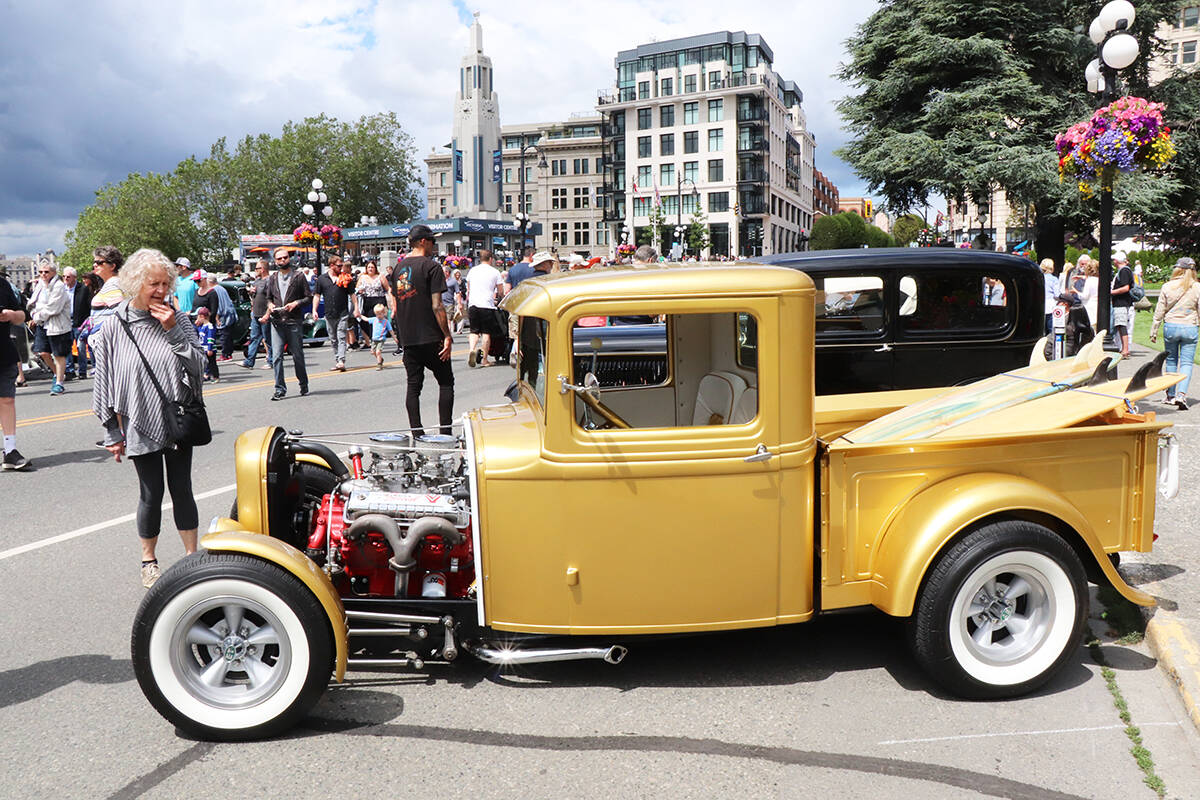 A vintage Ford pickup truck catches attention with a pair of surfboards in the bed. It was one of the hundreds of vehicles lining the Inner Harbour on Sunday during the Northwest Deuce Days show and shine. (Don Descoteau/News Staff)