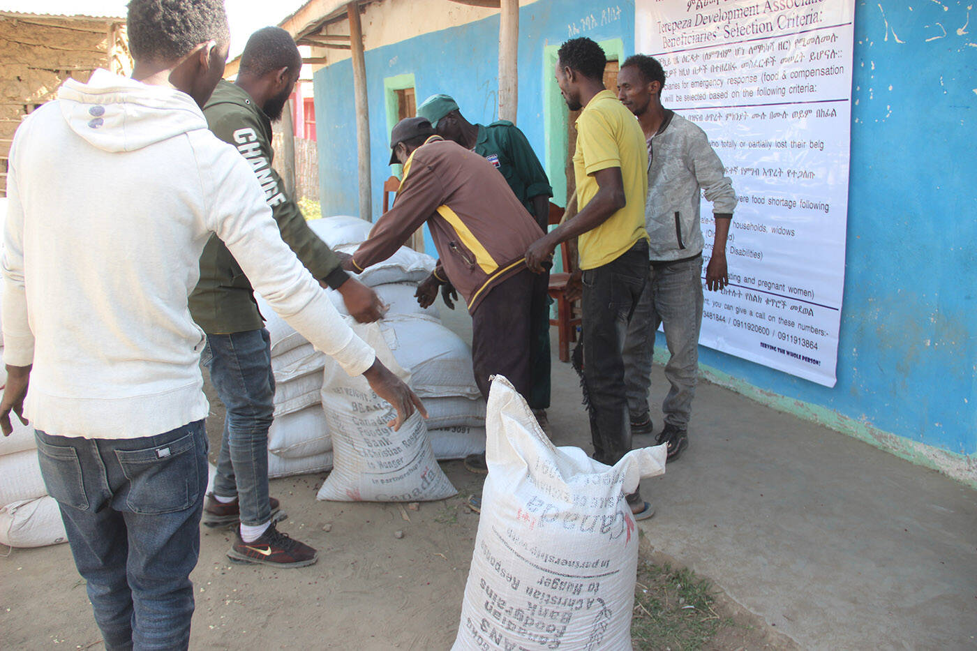People help distribute food from Canadian Foodgrains Bank in Ethiopia in July. (Canadian Foodgrains Bank)