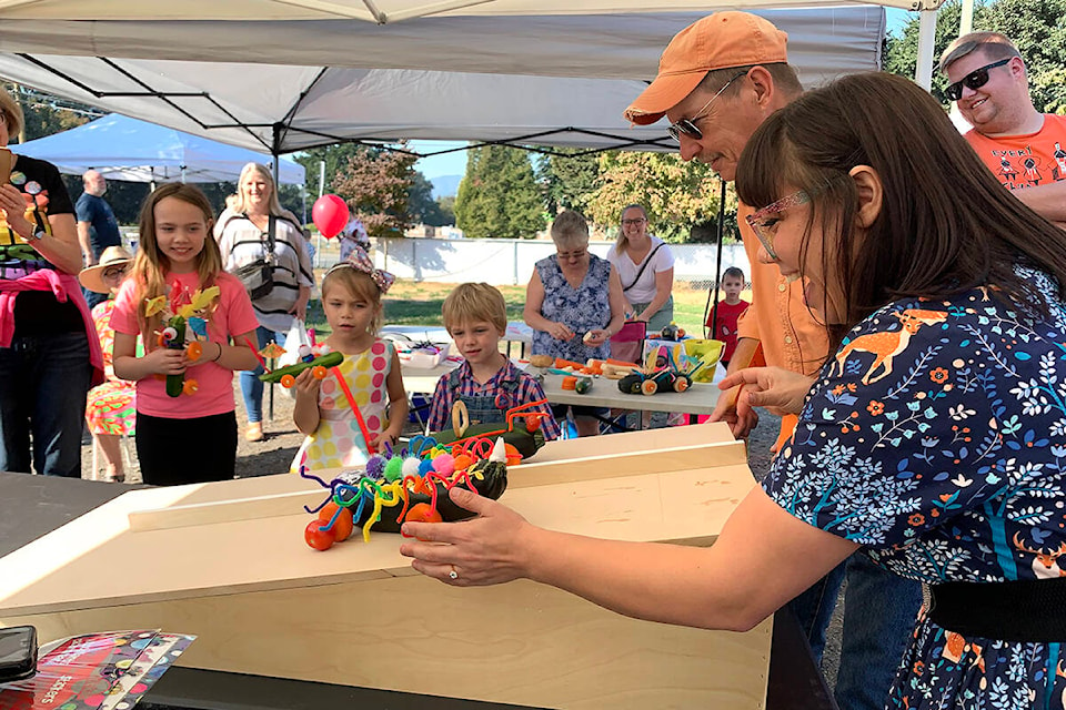 Chilliwack school board candidate Margaret Reid and mayoral candidate Ian Carmichael faced off in the first zucchini boat race of the day at the Sardis Neighbourhood Market on Saturday, Oct. 1. (Jessica Peters/Black Press Media)