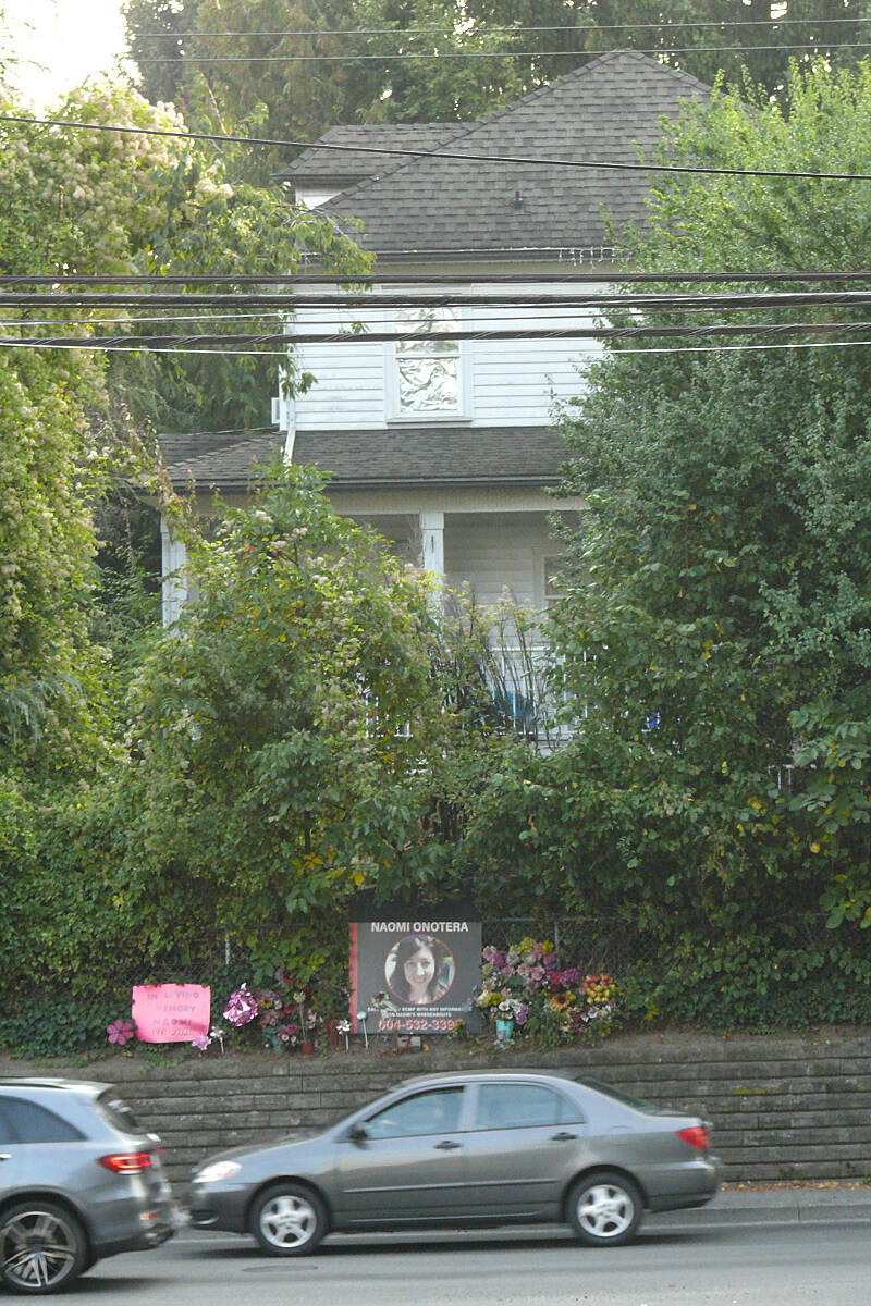 A memorial remains outside the home of Langley City homicide victim Naomi Onotera, who died in 2021. On Monday, Oct. 3, online ads to sell the house on 200th Street were posted. (Dan Ferguson/Langley Advance Times)
