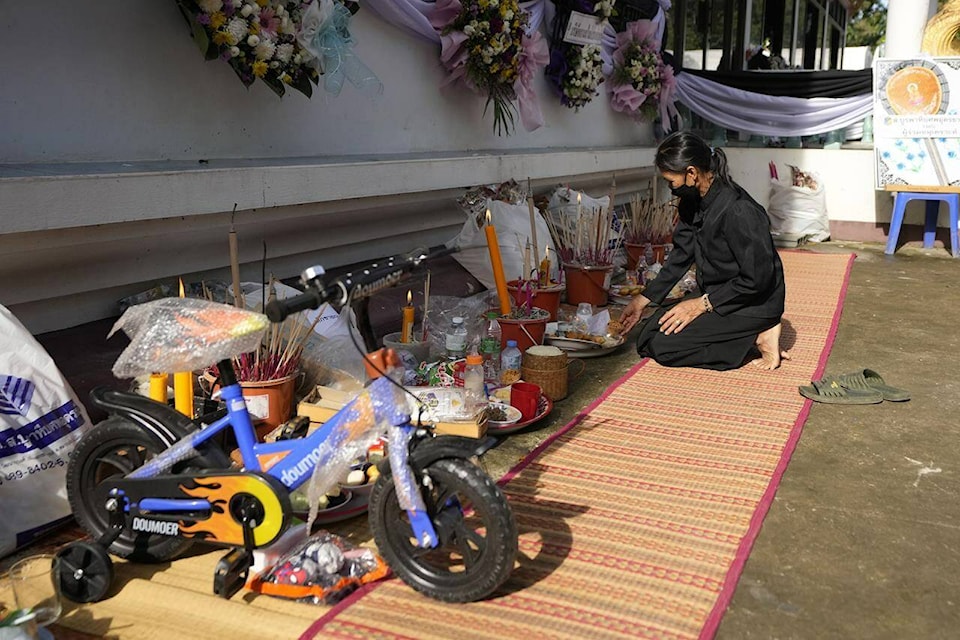 Toys and other keepsakes are offered for the victims of a mass killing attack gather for a Buddhist ceremony inside Wat Rat Samakee temple in the rural town of Uthai Sawan, north eastern Thailand, Sunday, Oct. 9, 2022. A former police officer burst into a day care center in northeastern Thailand on Thursday, killing dozens of preschoolers and teachers before shooting more people as he fled. (AP Photo/Sakchai Lalit)