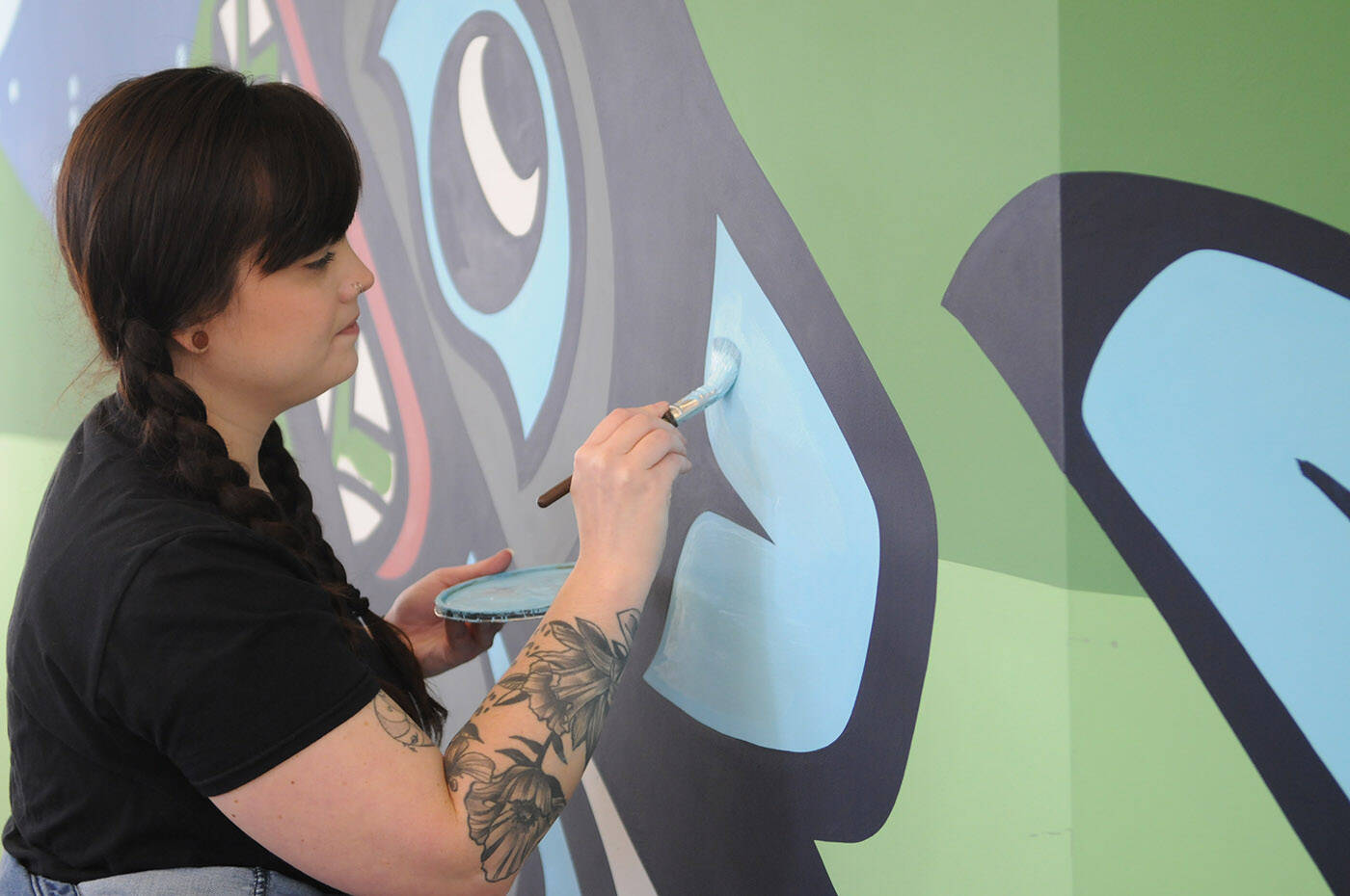 Artist Chantelle Trainor-Matties works on her mural at the Chilliwack Library on Nov. 8, 2022. (Jenna Hauck/ Chilliwack Progress)