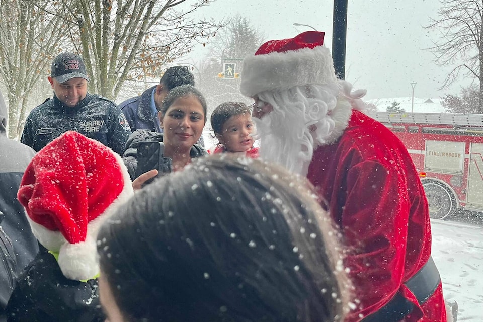 Santa Claus arrived by fire truck at the Tong Louie YMCA in Surrey on Sunday, to help the Surrey Fire Fighters Charitable Society hand out presents at their annual Adopt a Family event. (Tricia Weel photo)