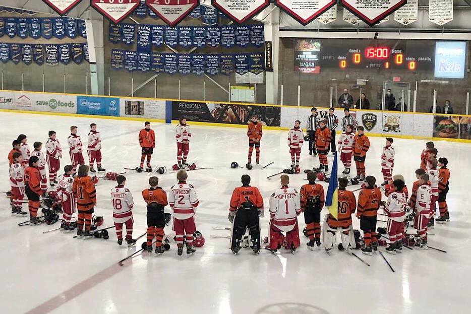 Members of the Semiahmoo and Ridge Meadows U11 A1 teams come together at centre ice prior to their game Saturday to show support for Ukraine, and Semiahmoo's Ukrainian-born goaltender, Dmytro Makogonsky. (Contributed photo)