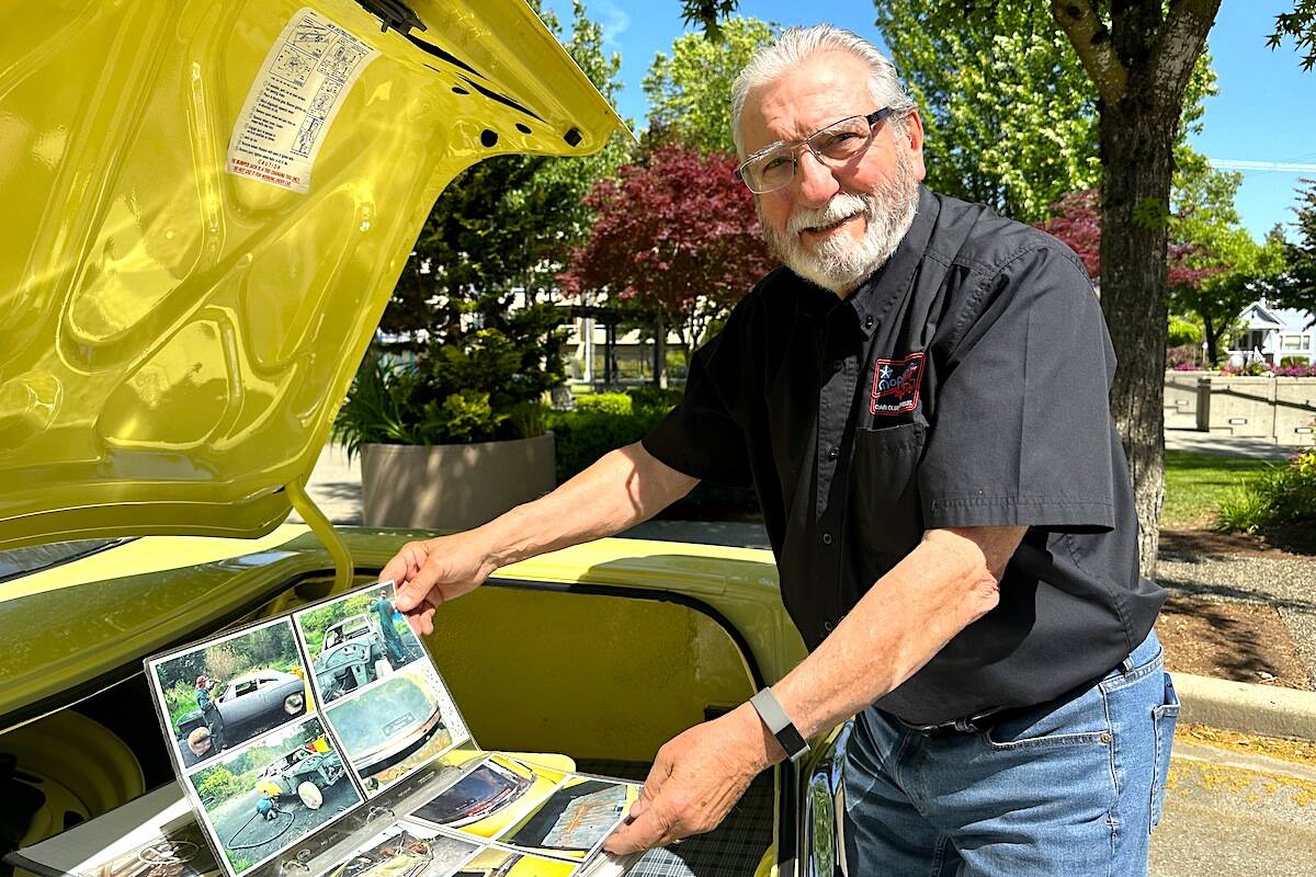 Dennis Hupka with his 1969 Plymouth Road Runner and his binder recording the transformation from a mouse house to a gleaming collectible. (Jennifer Feinberg/ Chilliwack Progress)