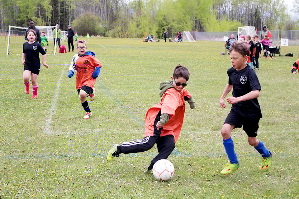 On May 24 at Four Seasons Park, Houston U8 and U10 hosted their home soccer tournament. There were 15 U8 teams that scattered the field with pink, green, black, white, yellow, and orange jerseys. The teams travelled from Smithers and Telkwa. Houston teams were in the Orange jerseys. The U8 teams started playing at 9 a.m. and then at noon, U10 teams played at 1 p.m. With intermittent rain the soccer fields became a little slick which added to the challenge of controlling the ball. Parents cheered on while bundled up in lawn chairs.