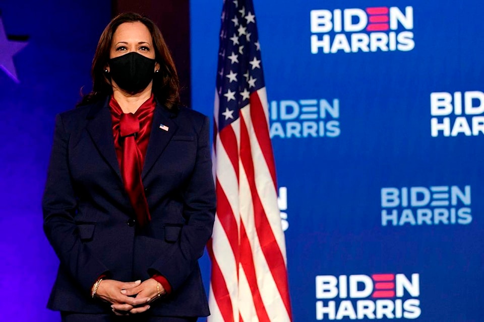 Democratic vice presidential candidate Sen. Kamala Harris, D-Calif., listens as Democratic presidential candidate former Vice President Joe Biden speaks Friday, Nov. 6, 2020, in Wilmington, Del. (AP Photo/Carolyn Kaster)