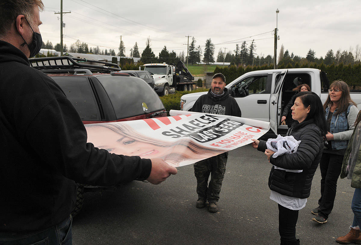 Alina Durham (right) looks at the 16-by-four-foot banner with her daughters face on it. Shaelene Keeler Bell of Chilliwack was last seen on Jan. 30, 2021. (Jenna Hauck/ Chilliwack Progress)