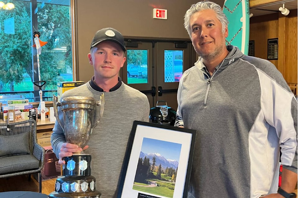 Smithers Golf and Country Club director of golf operations Steven Coulthard presents the Men’s Northern Open trophy to 2022 winner Joel Veenstra. (Submitted photo)