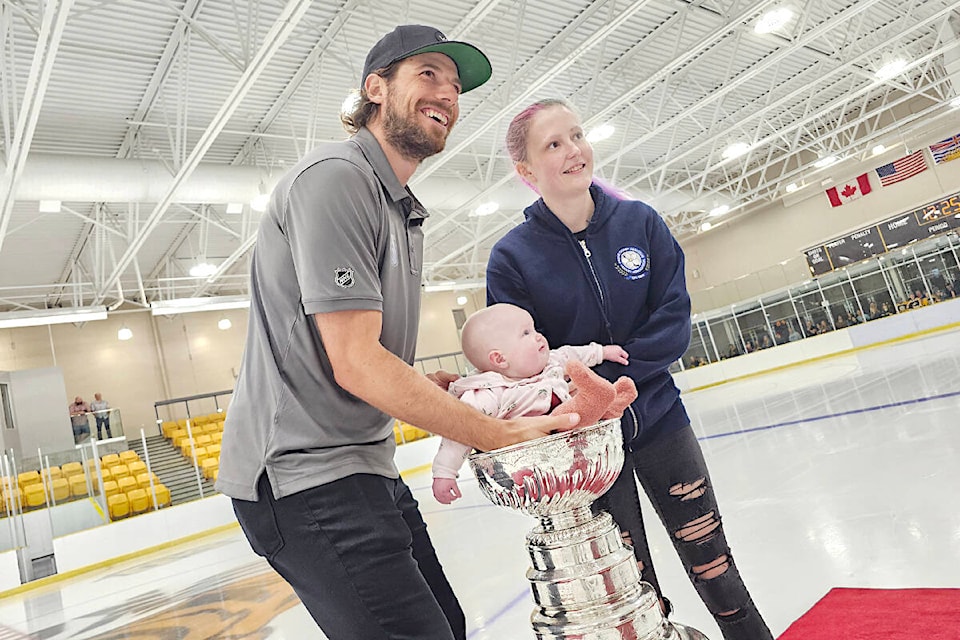 Six-month-old Marcelina had her picture taken, seated in the Stanley Cup, with her mom, Hailey Reid, from Abbotsford, and Aldergrove’s Shea Theodore, who had brought the trophy to his hometown on Tuesday, Aug. 29. (Dan Ferguson/Langley Advance Times)