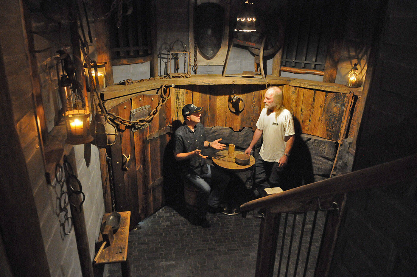 Rob Forde chats with Mark Gore on Oct. 21, 2023. Forde transformed the Gore familys crawl space into a dungeon. (Jenna Hauck/ Chilliwack Progress)