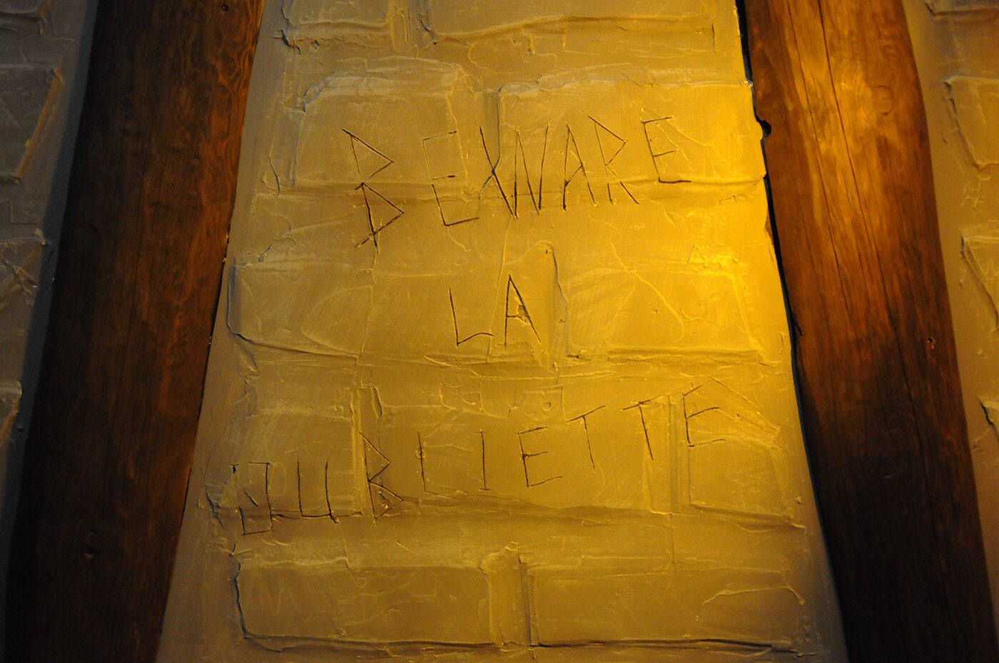 Beware la oubliette is etched into the ceiling of the Gore familys crawl space which was transformed into a dungeon by Rob Forde. (Jenna Hauck/ Chilliwack Progress)