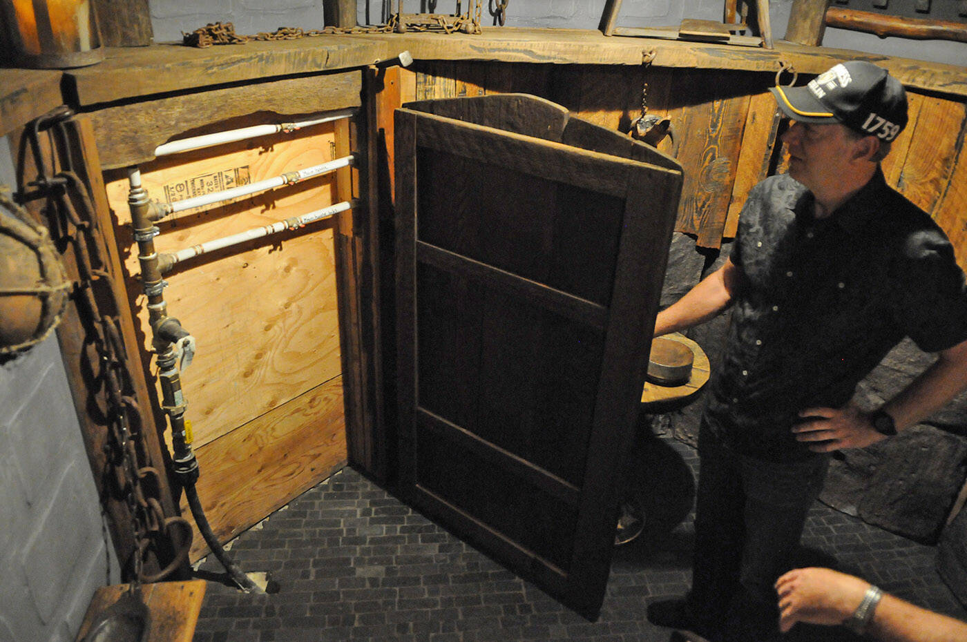 The water shut-off valves are hidden behind a door in Mark Gores dungeon crawl space. (Jenna Hauck/ Chilliwack Progress)