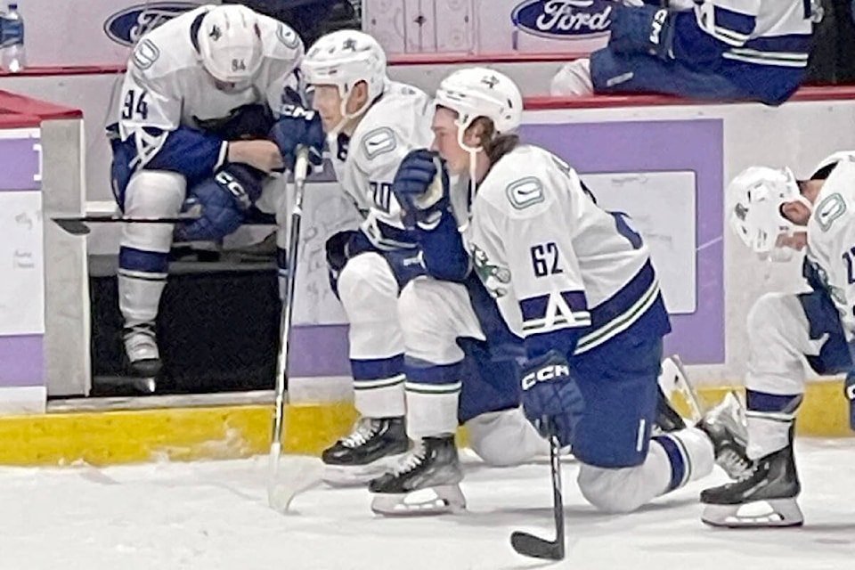 Canucks players take a knee as medical staff tends to teammate Vasily Podkolzin, who suffered a serious injury on Wednesday (Oct. 25) against Colorado. (Kevin Gillies photo)