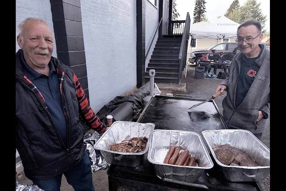 Houston Royal Canadian Legion Branch 249 president Ambrose Kelly, left, and director Gary Timms, right, took care of things at a community barbecue Sept. 14 to celebrate the branch's 70th anniversary.