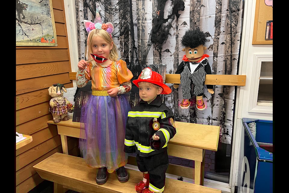 Paisley and Bradley enjoy the photo booth at the Smithers Public Library's Haunted Halloween event on Friday. 