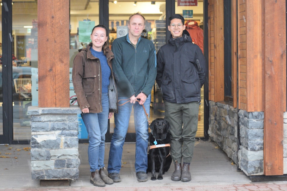 Graduation day for a guide dog. From left, Rachel Nelson from B.C. Alberta Guide Dogs; Seighard Weitzel, owner of Outdoor Essentials; Babs, Weitzel's new companion; and Colin Yu, a neutral certified trainer outside Weitzel's main street business.