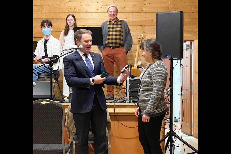 Skeena-Bulkley Valley MP Taylor Bachrach, left, presents Leslie-Jean MacMillan with the King Charles III Coronation Medal at the Valley Youth Fiddlers dance March 15. 