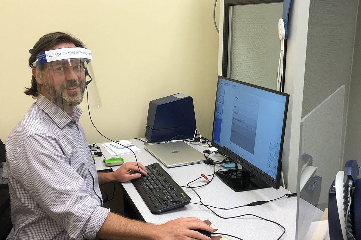 Victoria Audiologist Edward Storzer in the Island Deaf and Hard of Hearing clinic sitting outside the sound booth. Plexiglas separates him from clients and he wears a shield so clients can see his full face during their appointment. (Provided by Kristi Falconer) Victoria Audiologist Edward Storzer in the Island Deaf and Hard of Hearing clinic sitting outside the sound booth. Plexiglas separates him from clients and he wears a shield so clients can see his full face during their appointment. (Provided by Kristi Falconer)
