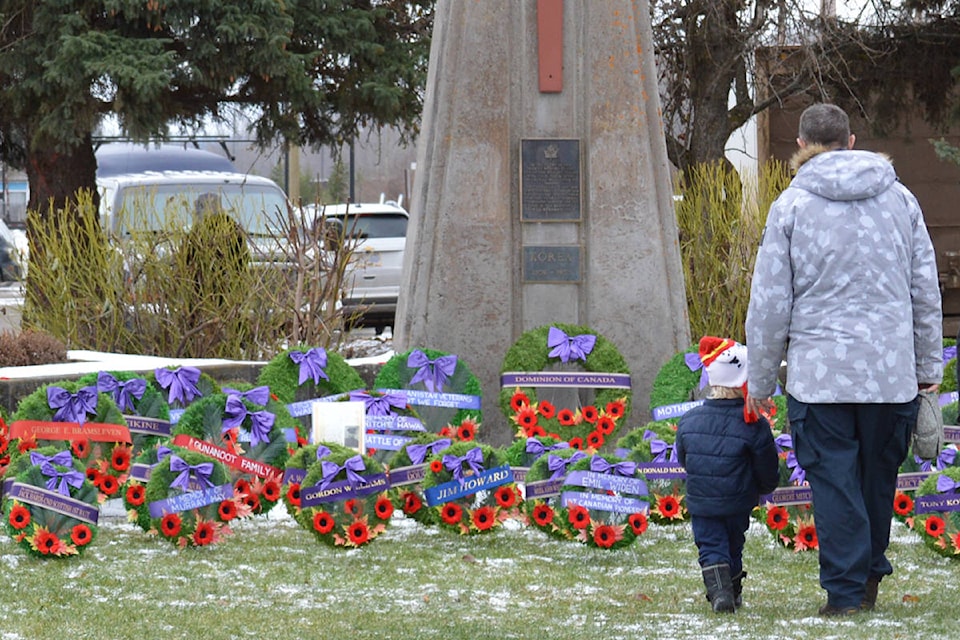 A small girl and her father approach the cenotaph at Veteran’s Peace Park to lay a handmade wreath at the cenotaph following the Remembrance Day ceremony Nov. 11. (Deb Meissner photo)