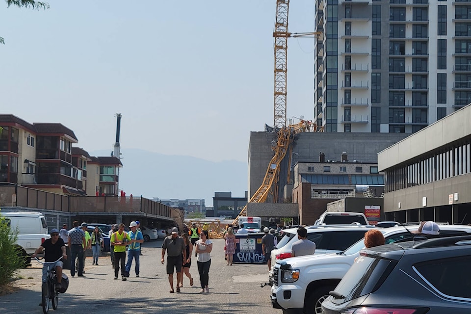 Emergency crews responding to a downtown Kelowna construction site after a crane fell on Monday, July 12. (Michael Rodriguez/Capital News)