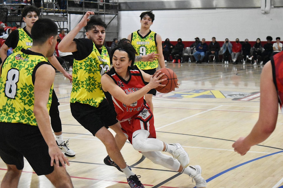 Bella Bella’s Marlo John (red) attempts to split Burnaby’s Ethan Sacco (left) and Gavin Bruce during Day 6 Intermediate play at the All Native Basketball Tournament in Prince Rupert April 8. (Thom Barker photo)