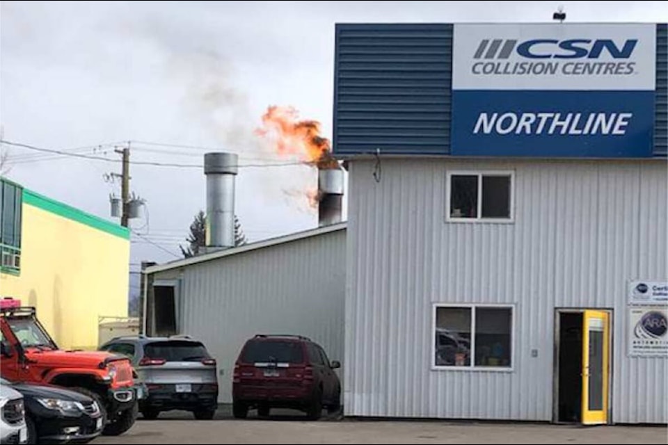 Flames pour from the roof stack at Northline Collision April 19. (Marisca Bakker photo)