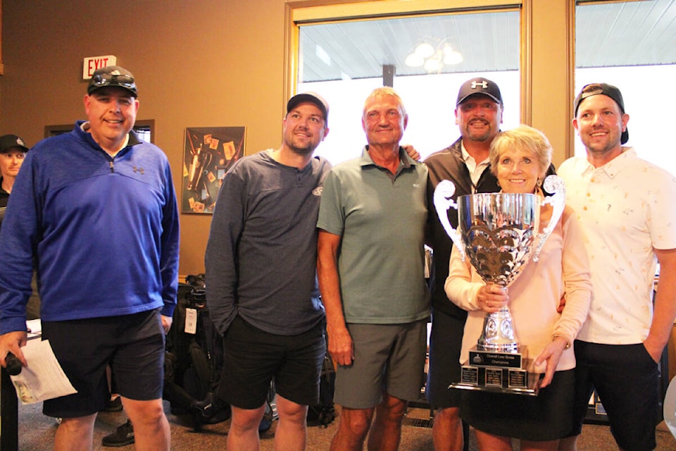 Smithers Celebrity Golf Tournament winners from Double A Ventures from Houston and their celebrity partner Tommy Greene (former MLB baseball star and broadcaster) hoist the trophy following an 18-under par round Aug. 13 at the Smithers Golf and Country Club. From left, emcee Steve Darling, Kevin Leffers, Andrew Leffers, Tommy Greene, Arlene Leffers and Ryan Leffers. (Thom Barker photo)