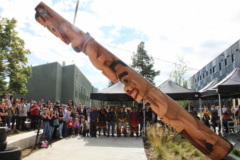 A totem pole being raised at the Coast Mountain College Terrace campus, in front of the new student housing building, Wii Gyemsiga Siwilaawksat, Aug. 31. (Michael Bramadat-Willcock/Terrace Standard)