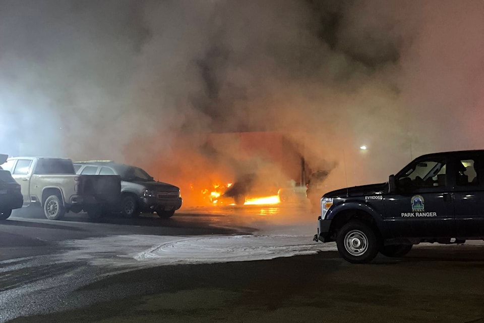 Vehicles in the parking lot between the Sunshine Inn and CIBC on Fourth Avenue in Smithers burn early Wednesday morning. (Contributed photo)