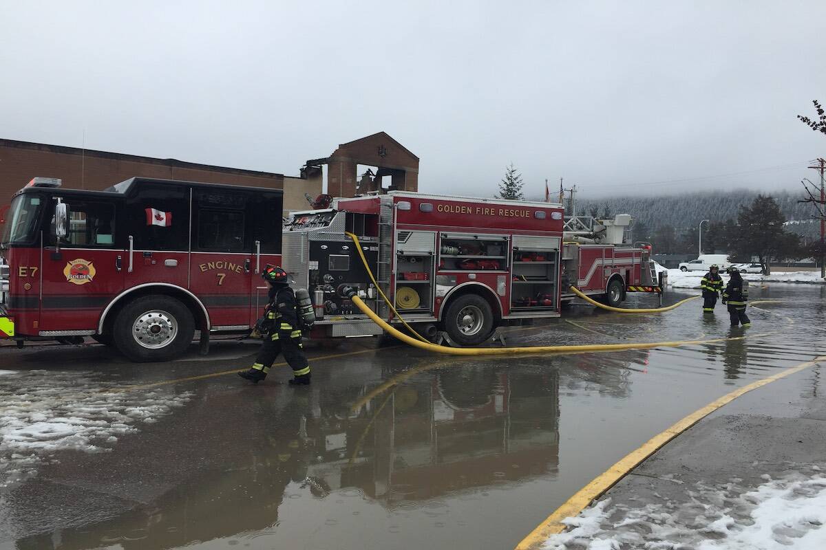 Fire crews clean up after blaze destroys law courts. (Michele LaPointe/ Golden Star)