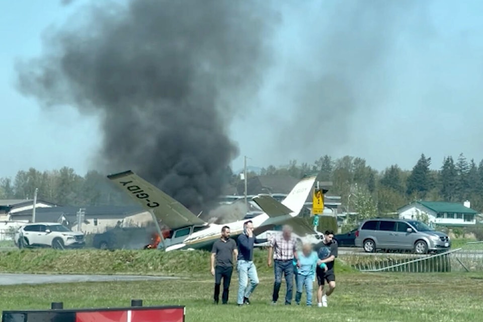 Moments after a light plane crashed at Langley airport, a passer-by captured video of some Good Samaritans rescuing the two occupants of the plane. (Special to Langley Advance Times)