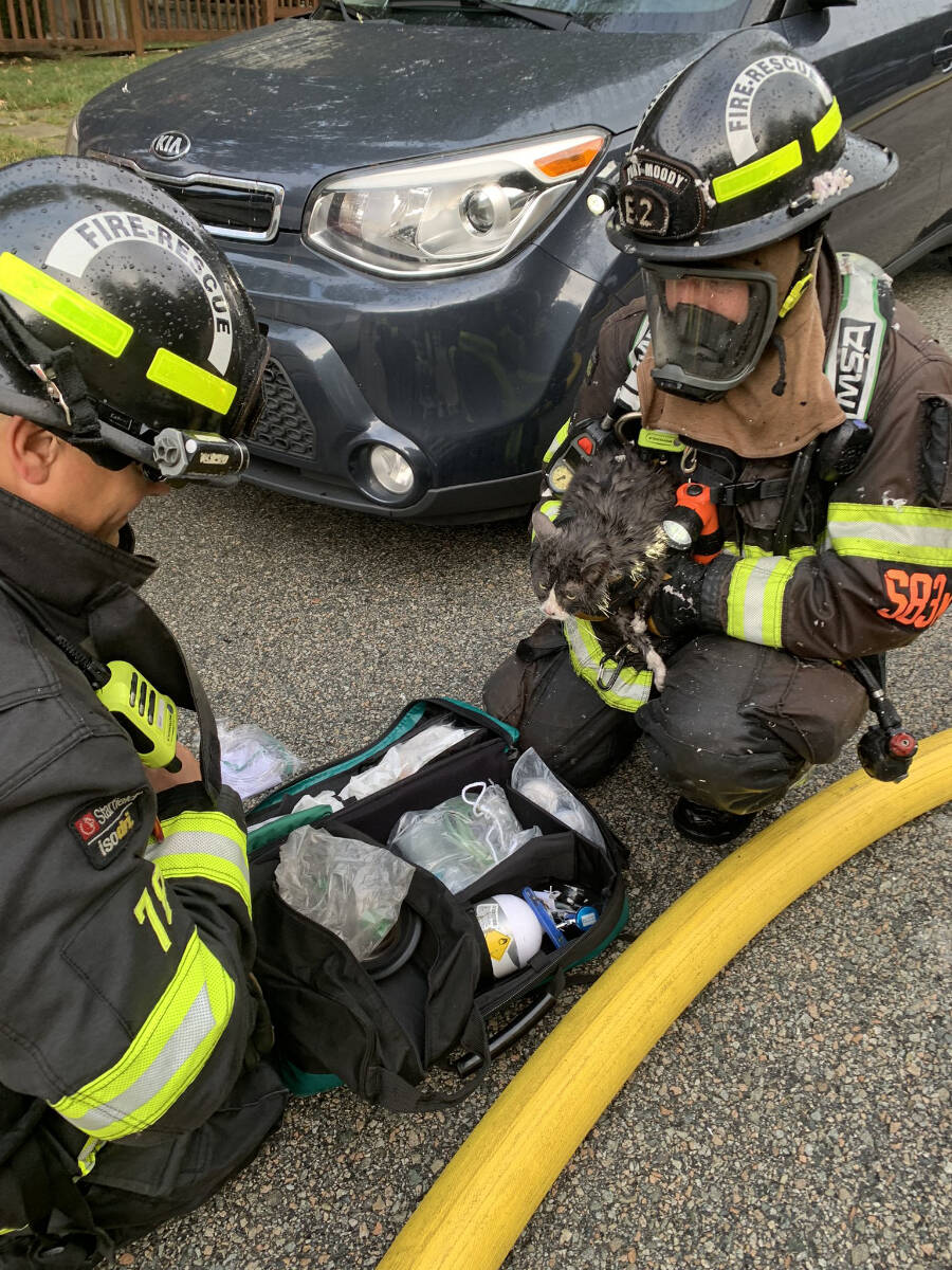 Three people were rescued from balconies during a fire at a Port Moody townhouse complex that police are calling suspicious. (Twitter/Port Moody Fire Rescue)