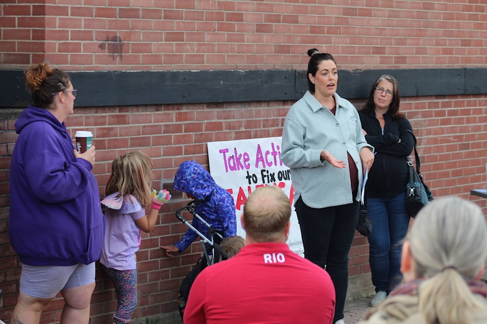 Jen Mio addresses a small crowd that gathered outside of Stikine MLA Nathan Cullen’s office on Sept. 5 to advocate for better health care. (Marisca Bakker/The Interior News)