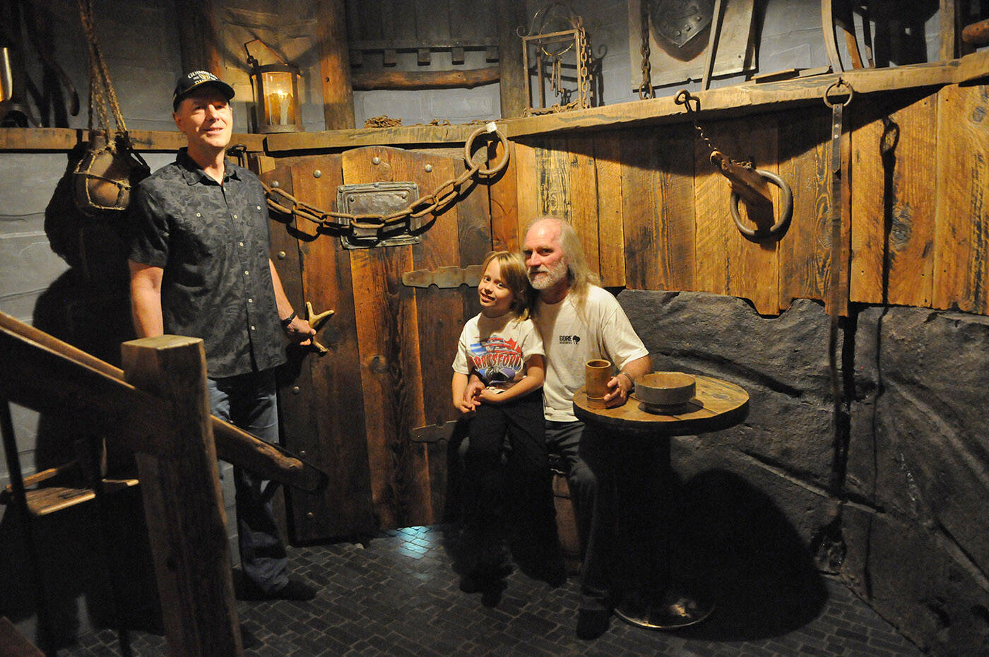 Rob Forde (left), seen here with Mark Gore and seven-year-old Jack Gore on Oct. 21, 2023, transformed the Gore familys crawl space into a dungeon. (Jenna Hauck/ Chilliwack Progress)